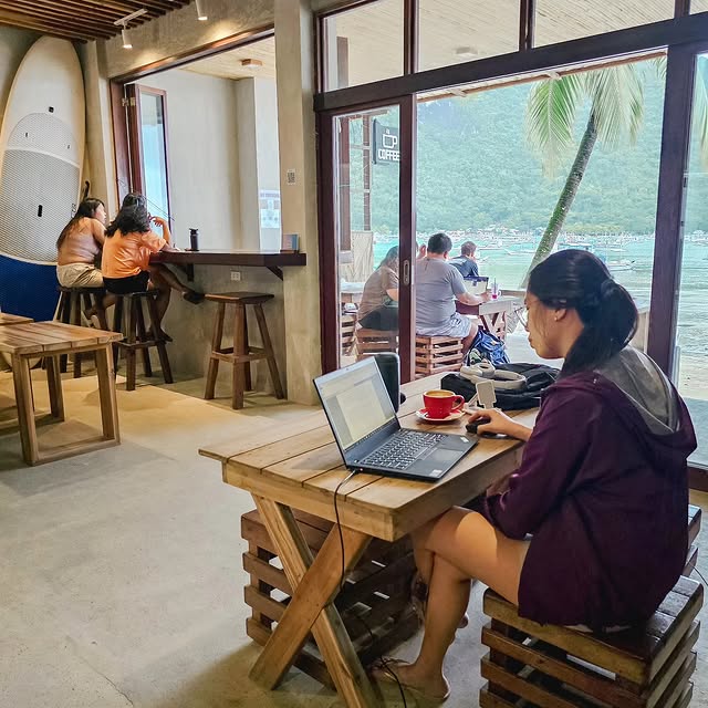 Guests working and relaxing at Hama Coffee with ocean view