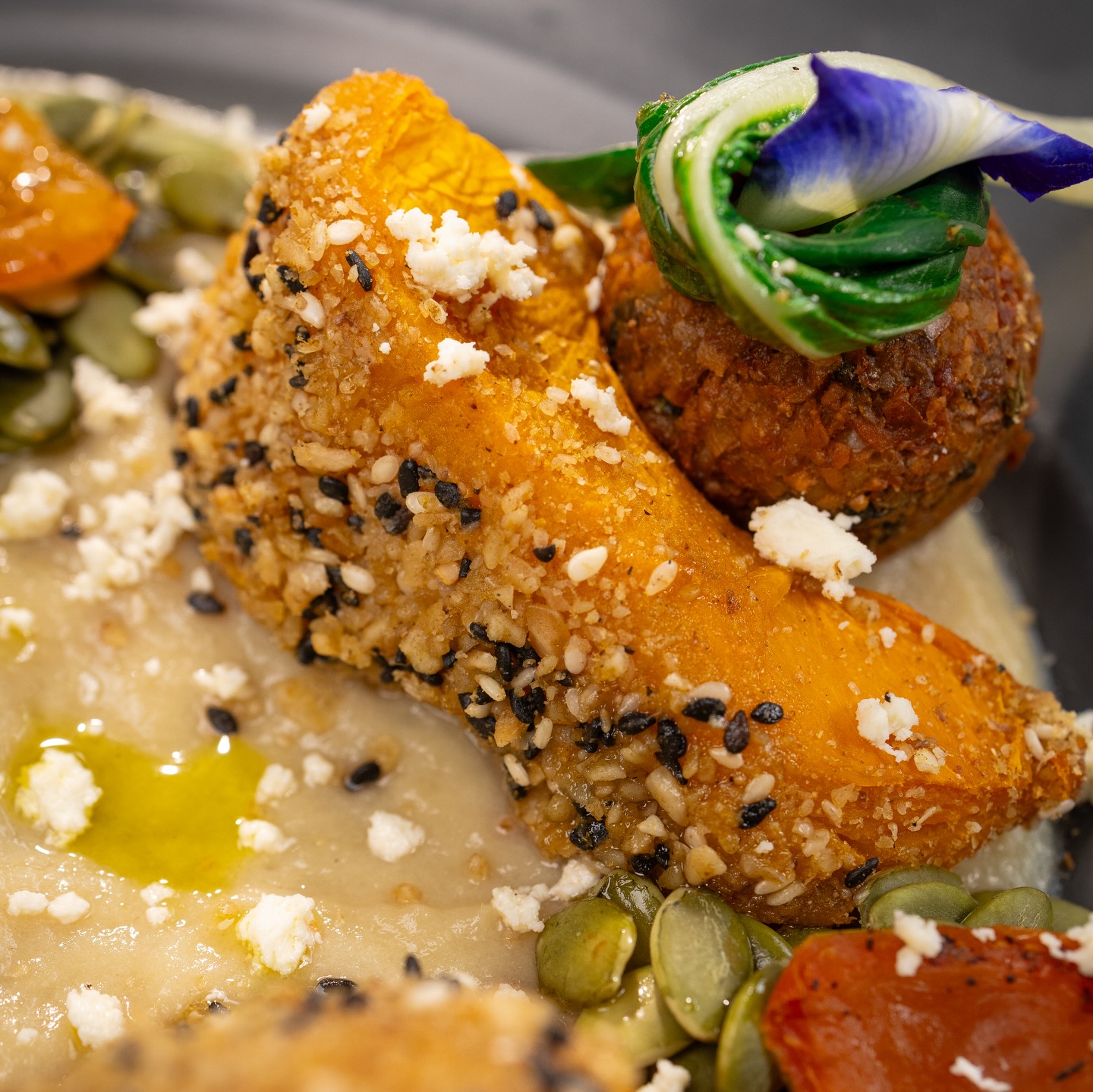Sesame-crusted squash with edible flowers