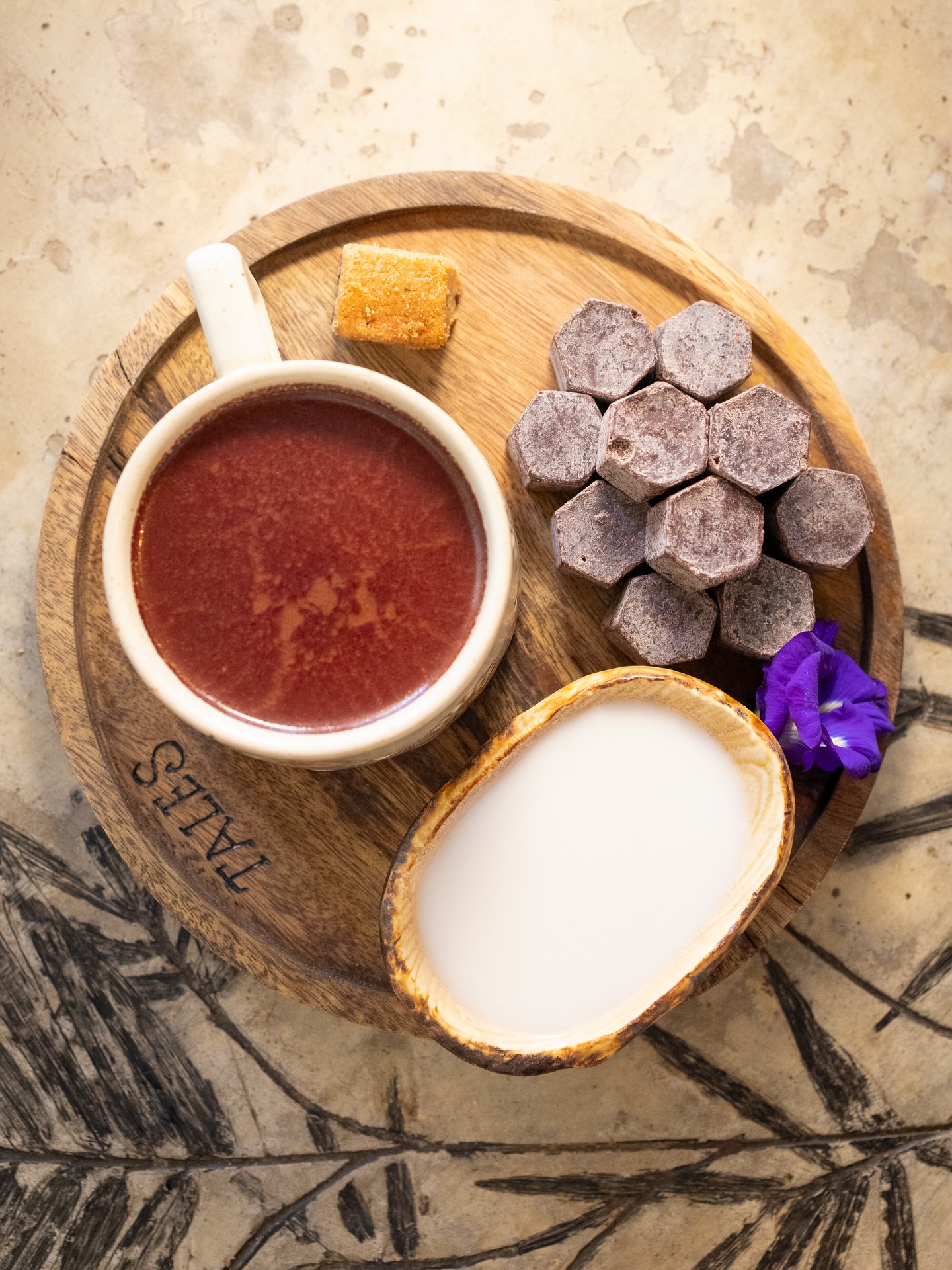 Tabelya cacao drink served on a Tales branded wooden board