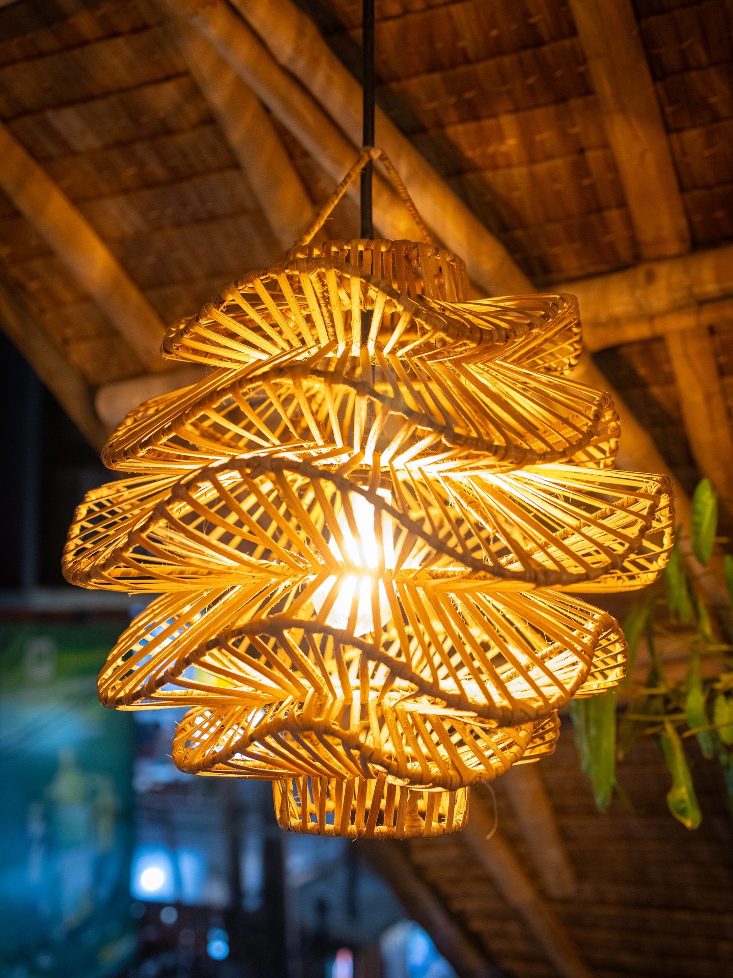 Warm rattan lanterns glowing inside Tales of the Islands El Nido